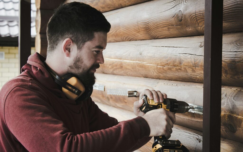 How to Save on Electricity Bill man in red long sleeve shirt holding black and yellow corded headphones